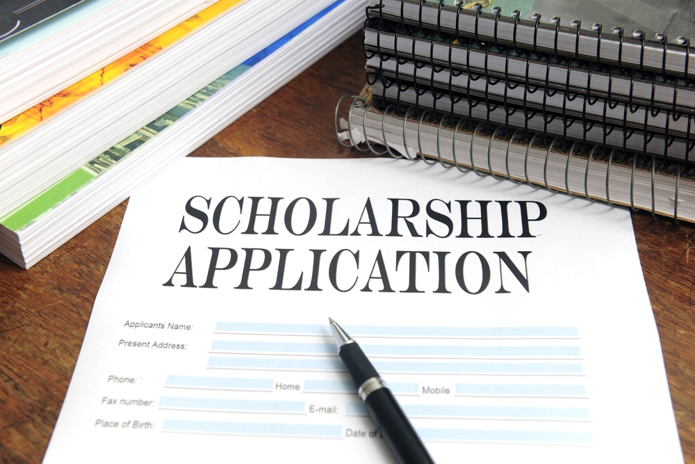 scholarship application on a desk with a pen