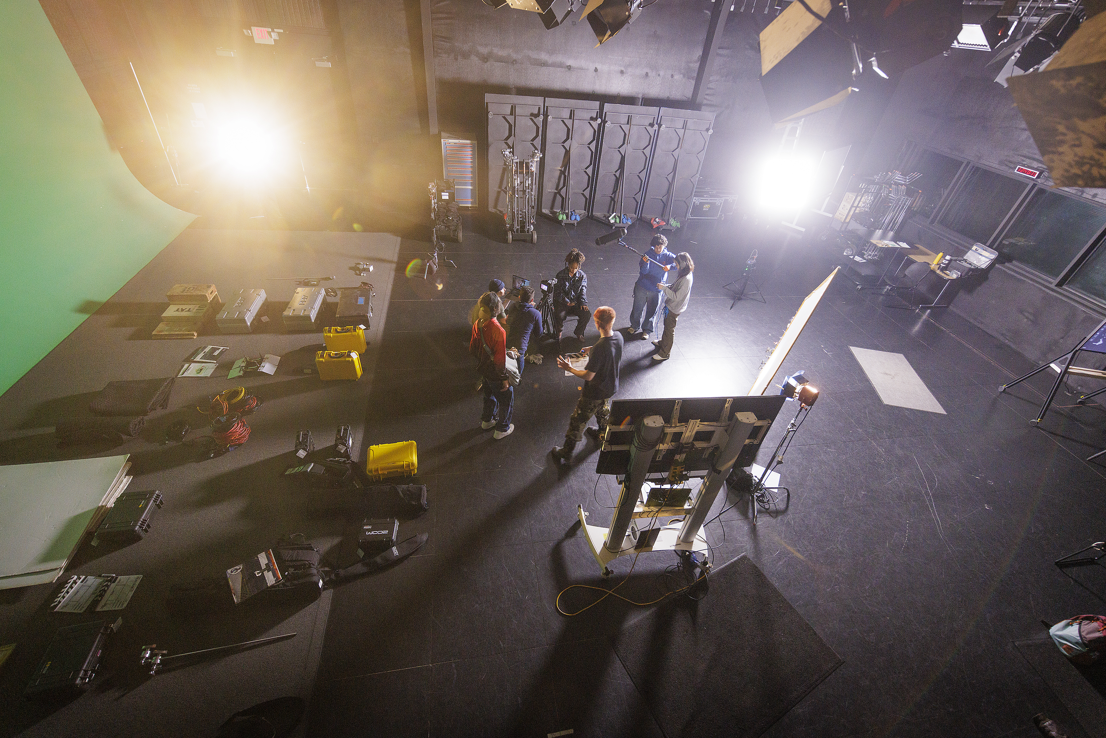 Overhead shot of a group of students in filming studio working on a film project